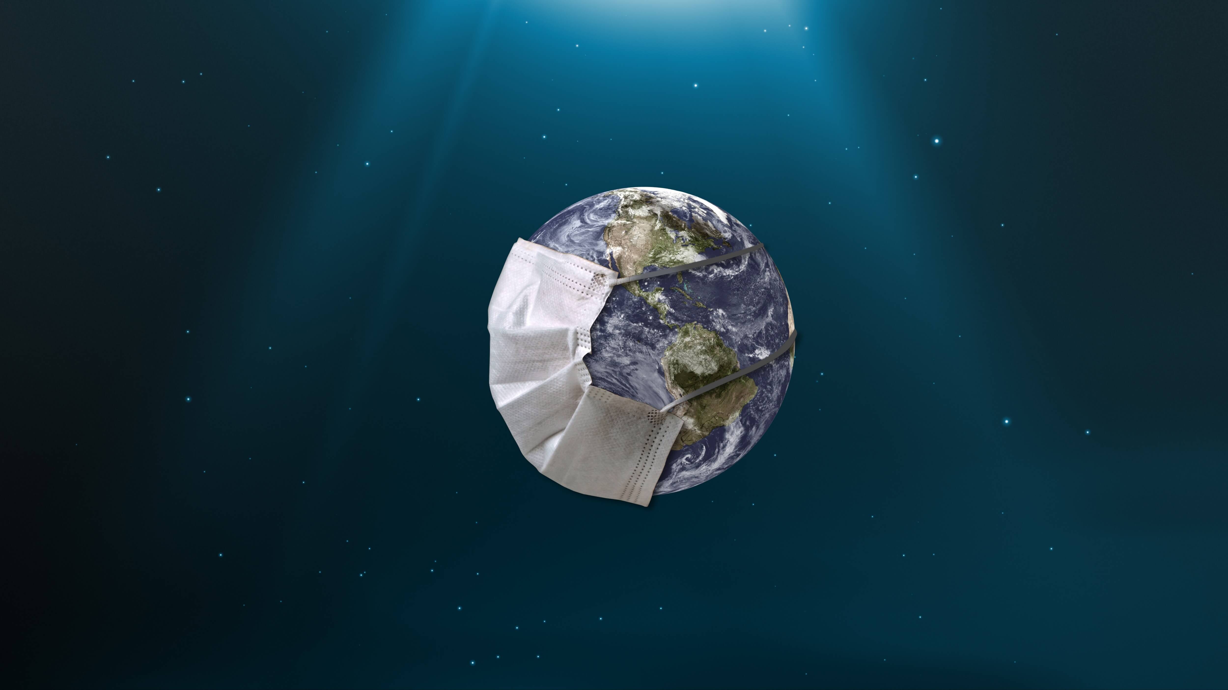 Weltkugel mit Mund- und Nasenschutz zur Pandemiezeit